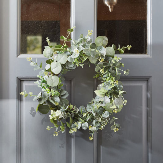 Green Eucalyptus Wreath Door Decoration hanging on a door