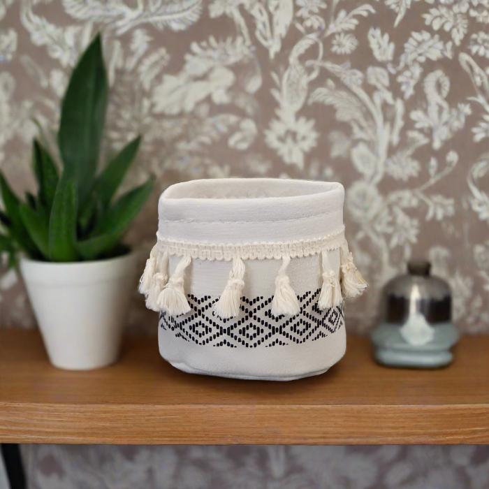 Black and White Tasselled Cotton Plant Pot Cover on a desk