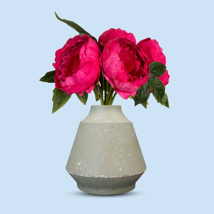 Fake fuchsia pink peonies in a green bell vase