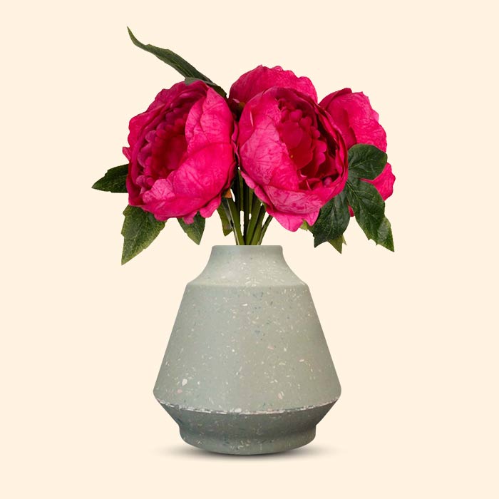 Artificial fuchsia pink peonies in a green bell vase