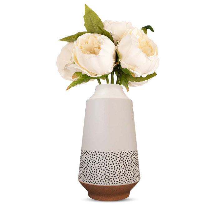 Ivory artificial flowers in tall white bamboo vase